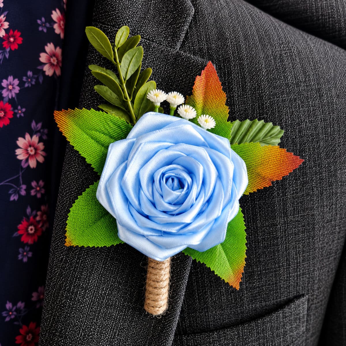 Bluebird satin rose buttonhole attached to a formal grey suit jacket lapel