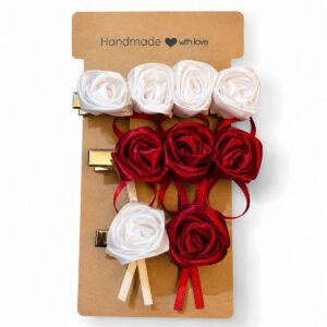 Handmade red and white satin rose hair clip set on display card